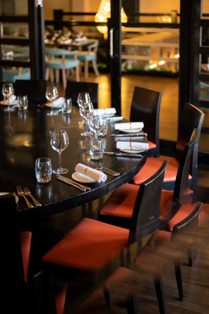 Dark round table with chairs around in Piccolino Hale's private dining room.